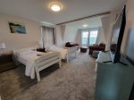 Twin Bedroom with leather love seats looking at Linekin Bay